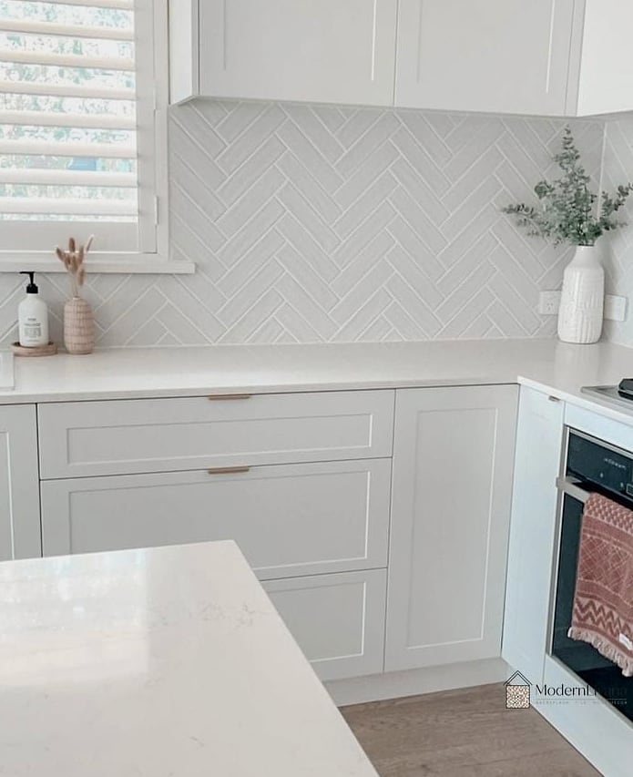 28 White Chevron Backsplash Ideas That Maximize Style and Function 5 Oversized Chevron Tile for Drama