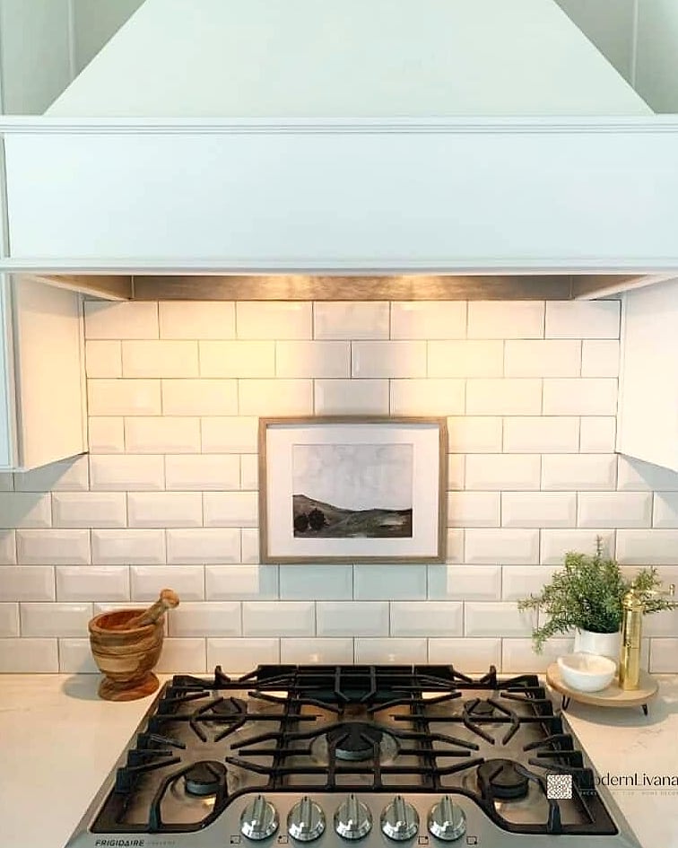 White Subway Tile Behind a Range Hood
