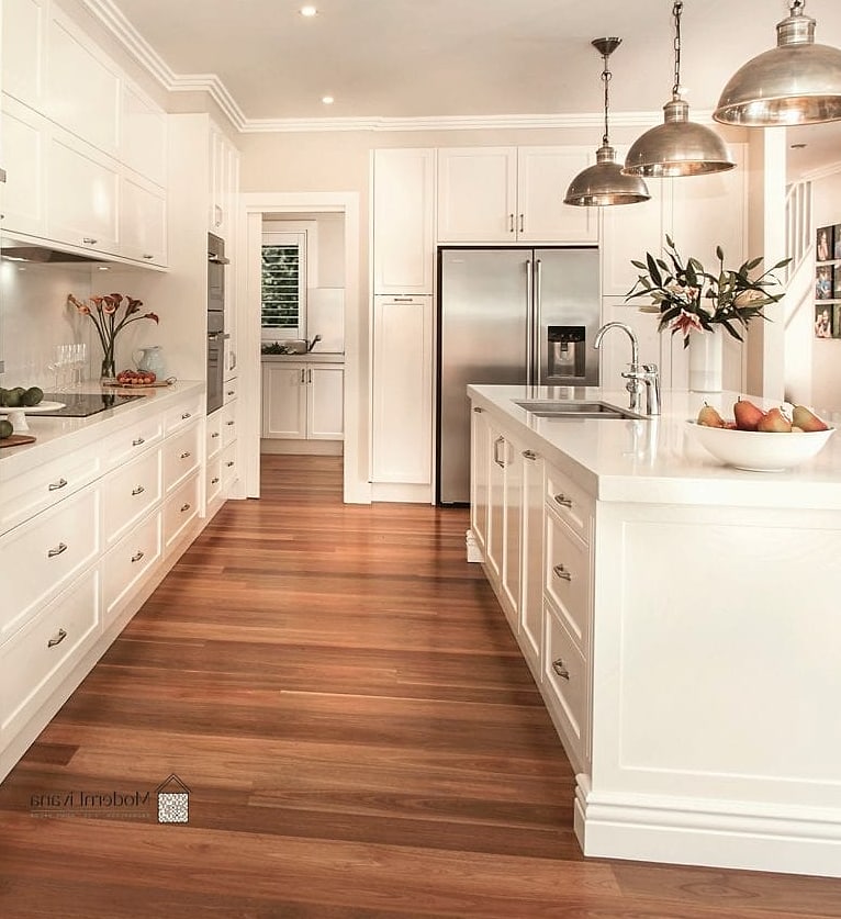 All-White Kitchen with Warm Wood Flooring