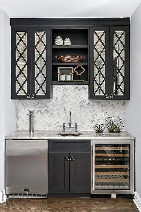 Black Cabinets with a Marble Herringbone Floor